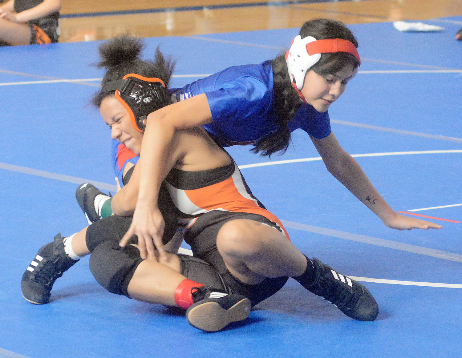 Briana Bodine (left) looks to take down her opponent during the tournament for Owensville.